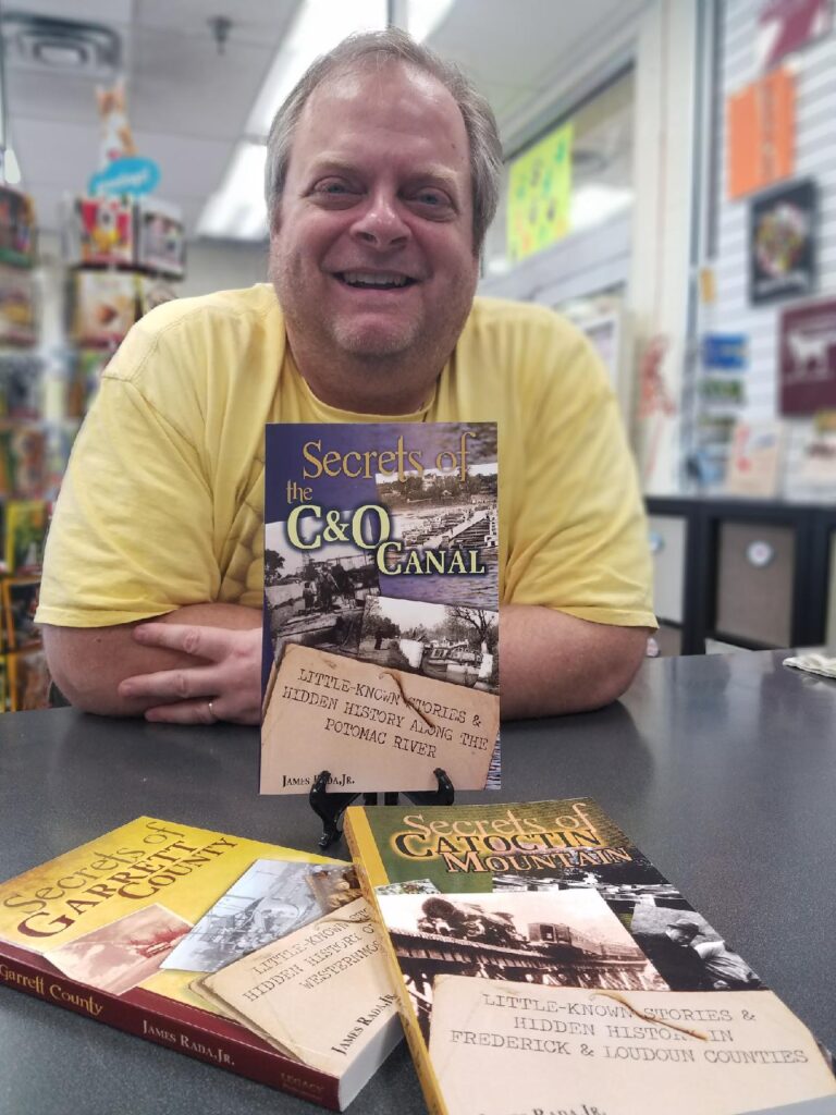 Jim Rada with some of his books